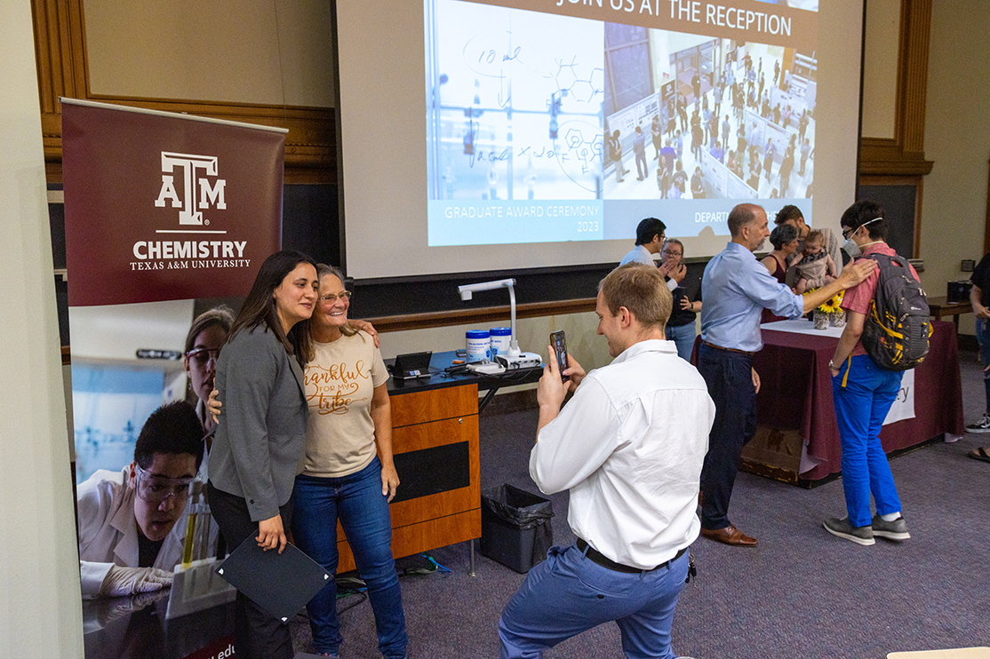 two women pose for photo at Chemistry event