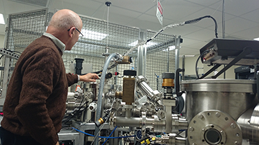 older man grabbing lab equipment