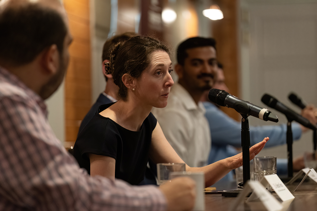 female speaking into microphone