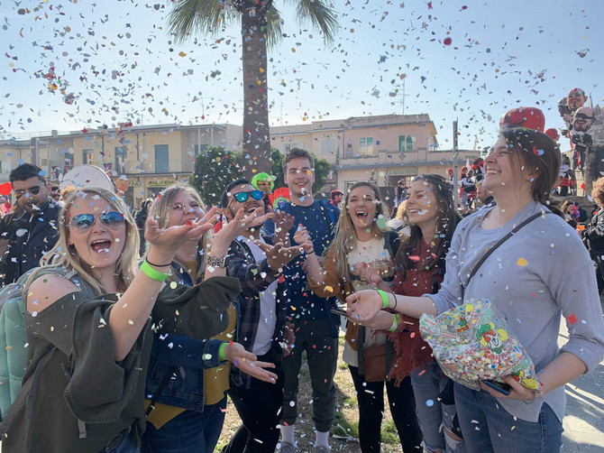 students throw confetti in carnival