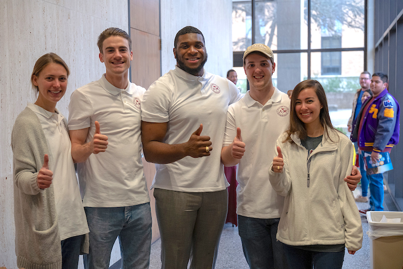 five Geology, Geophysics students giving a thumbs up gigem