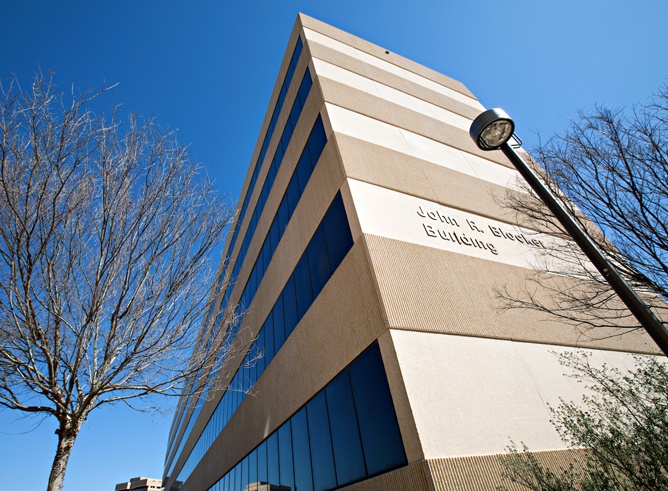 John R. Blocker Building is seen written across a several story building.