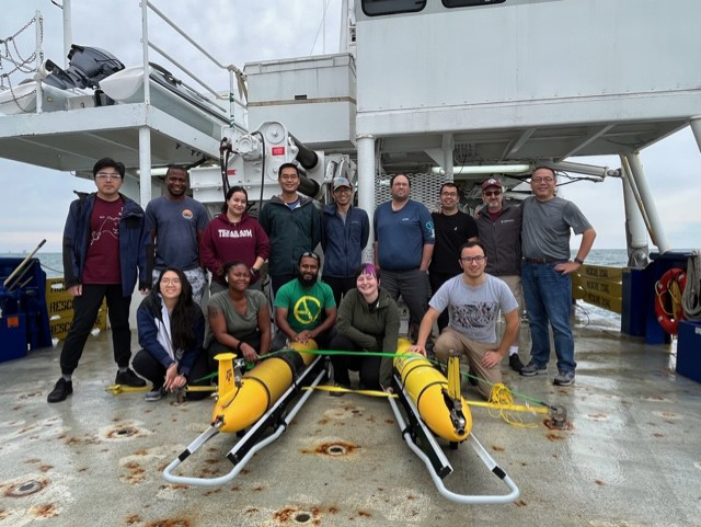 A group of researchers including Texas A&M professor and chief scientist Steven DiMarco on the deck of the R/V Pelican with two Teledyne-Webb Slocum buoyancy gliders