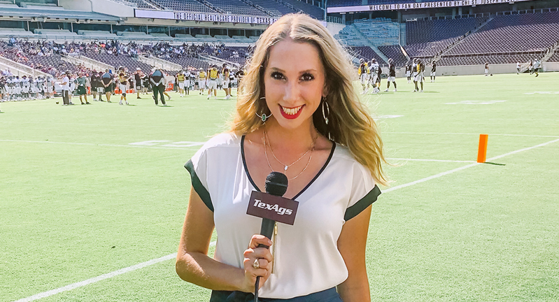 2019 Texas A&M telecommunications graduate Lia Musgrave holds a TexAgs microphone while reporting from the sidelines of Kyle Field at Texas A&M Football Fan Day