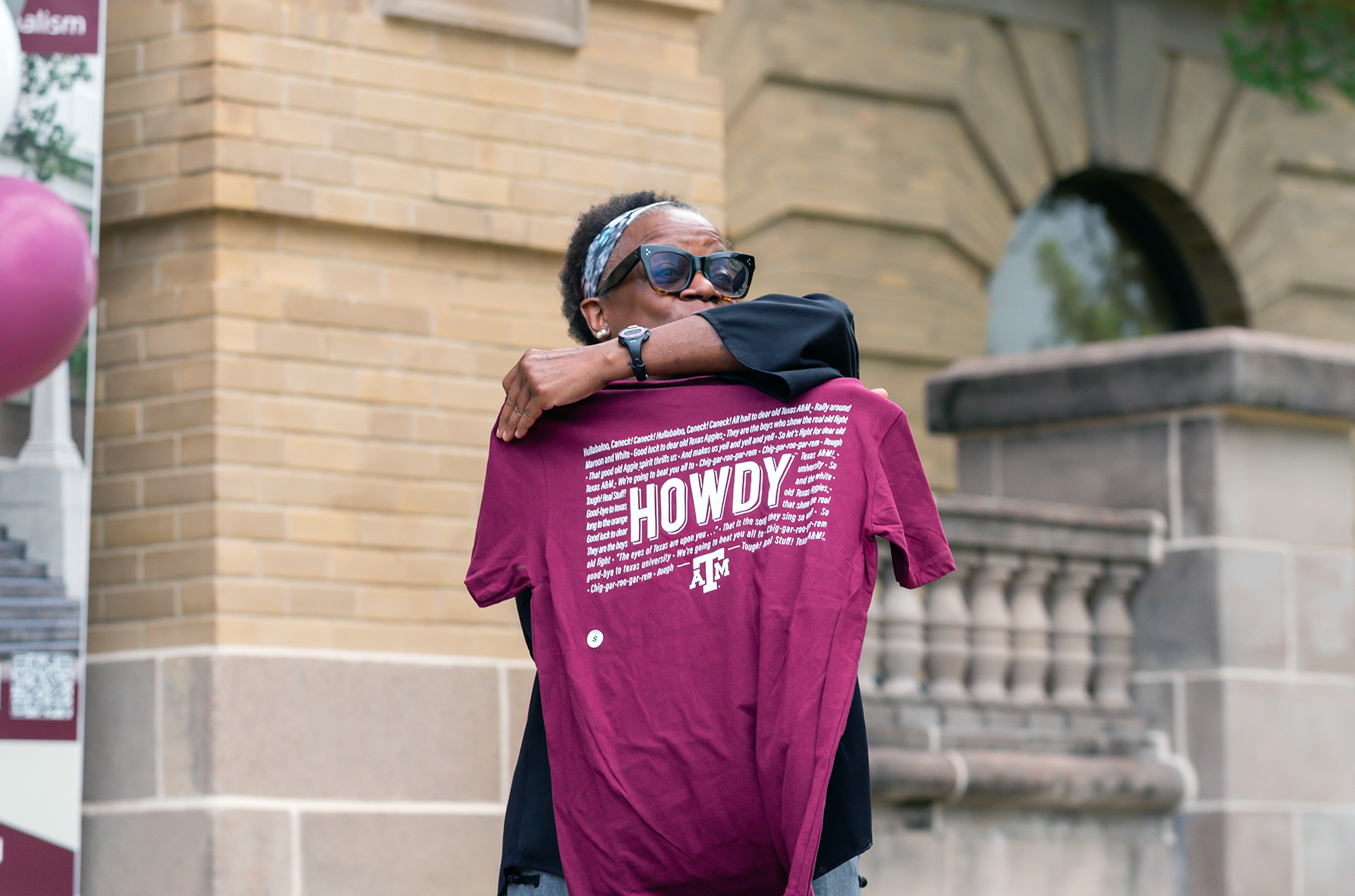 Kathleen McElroy displays her Howdy t-shirt presented by College of Arts and Sciences Interim Dean Dr. José Luis Bermúdez 