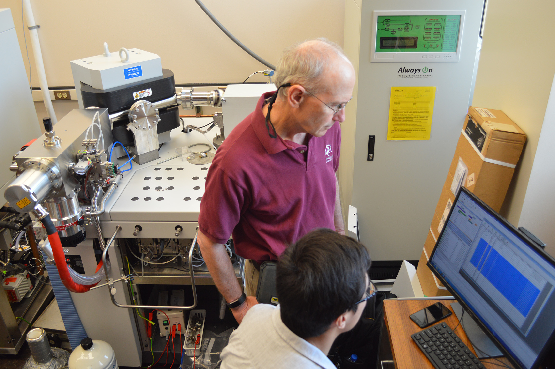 Texas A&amp;M geologist Ethan Grossman (standing) and Texas A&amp;M geology Ph.D. candidate Zeyang Sun (sitting), working in the Stable Isotope Geosciences Facility