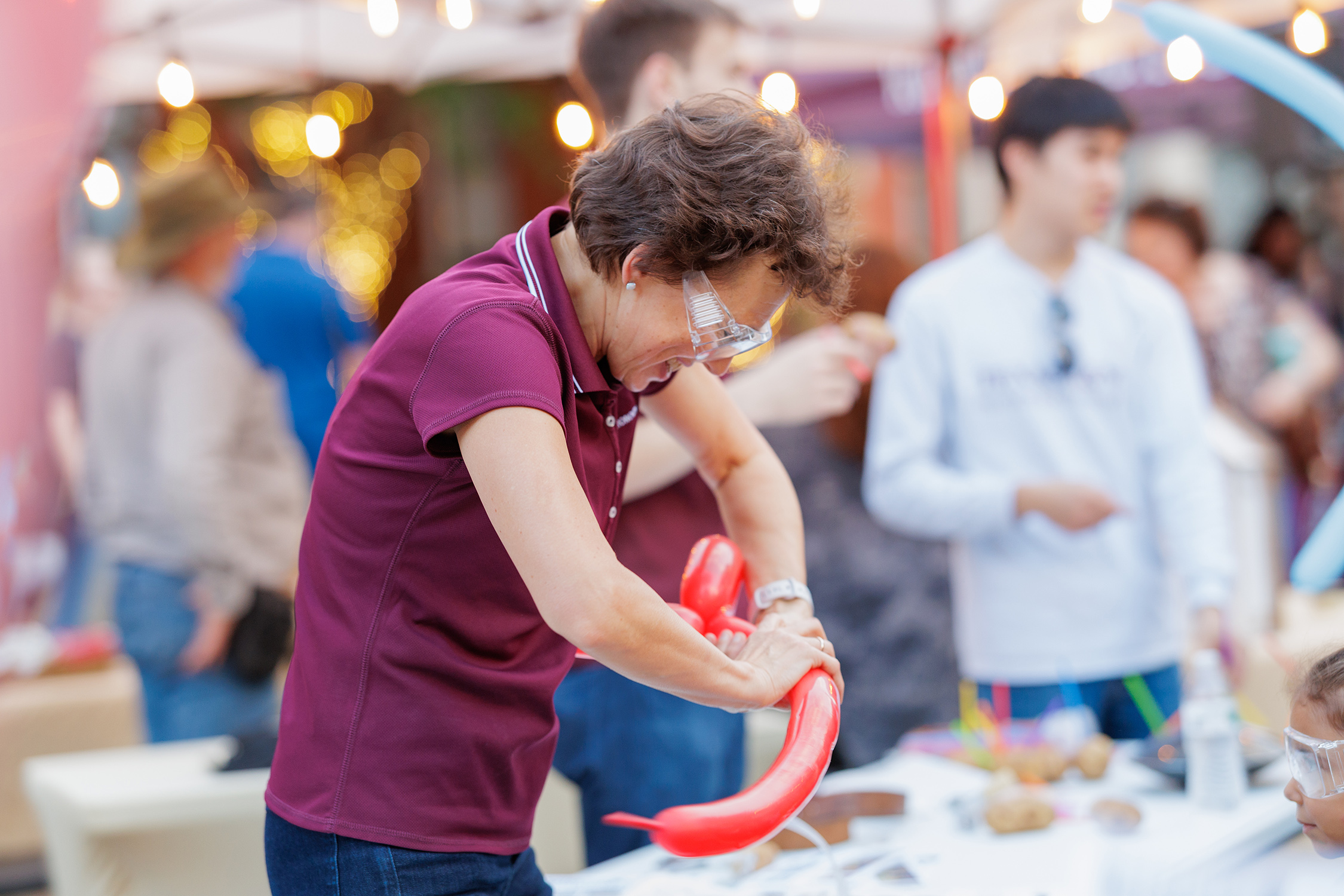 Texas A&amp;M physicist Tatiana Erukhimova makes a balloon animal at a Downtown Bryan First Fridays event 