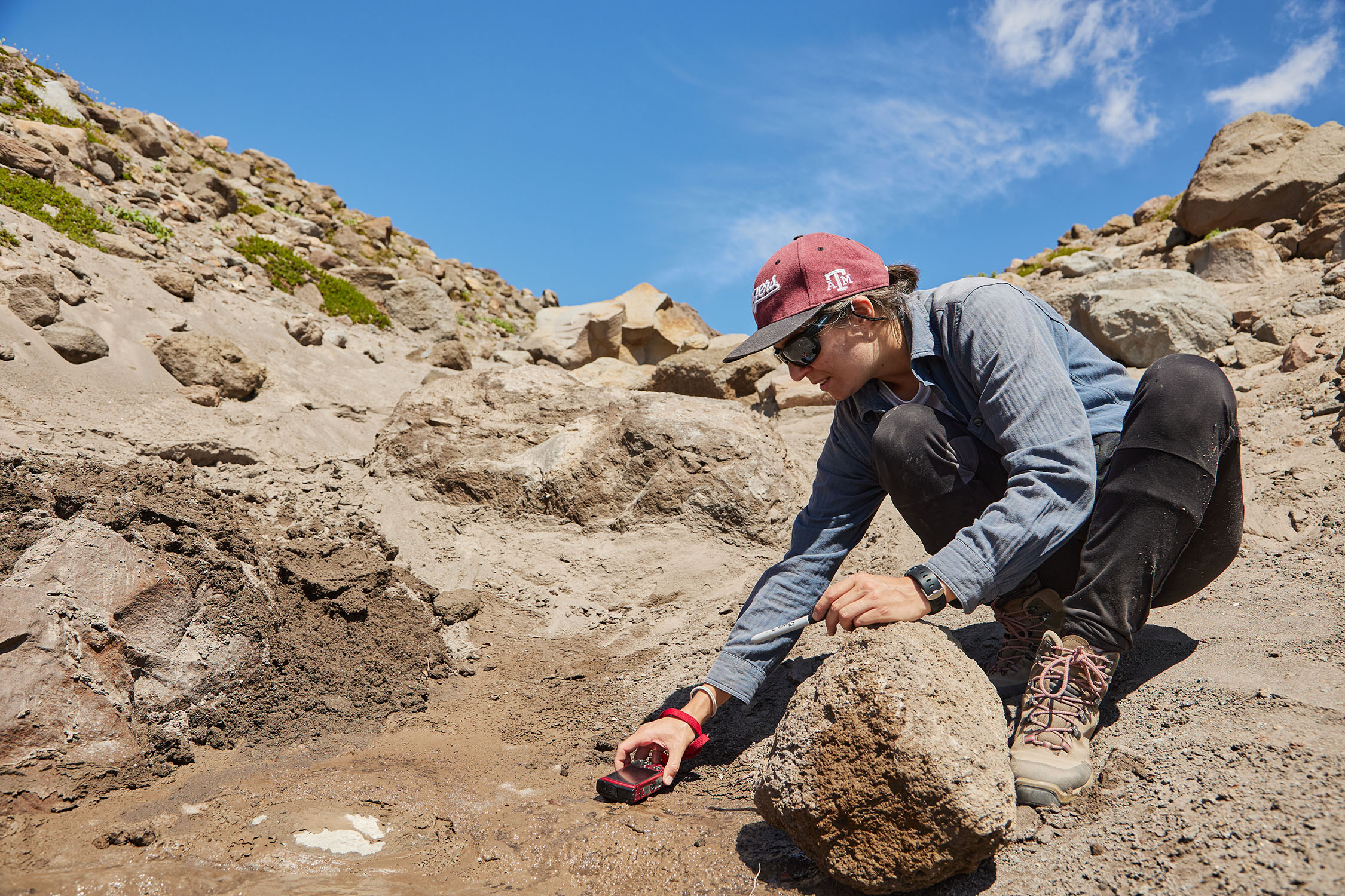 Texas A&amp;M University scientist Marion Nachon drives a small red truck through the soil at Mount Hood in Oregon during field testing in summer 2023