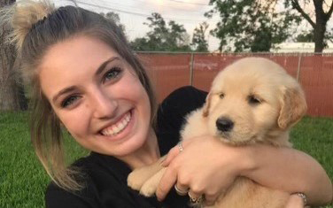 2020 Texas A&amp;M University economics graduate Noelle Levantino and her golden retriever, Charli