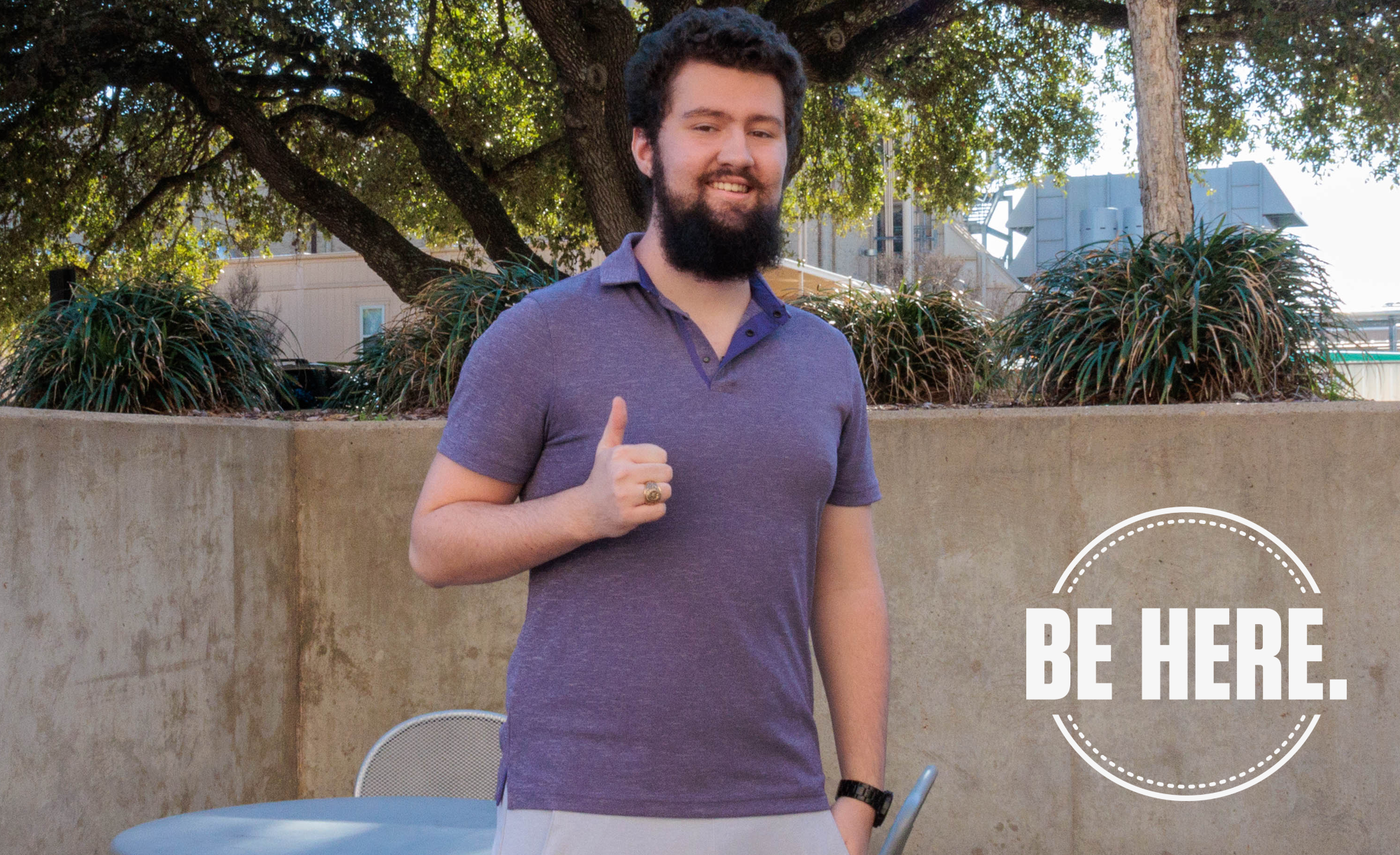 David Cates standing outdoors giving a thumbs-up with the text "BE HERE." displayed in the lower right corner.