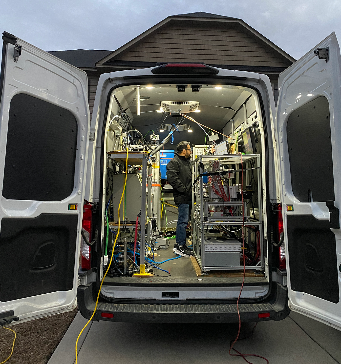 Sahir Gagan works inside a van filled with equipment and cables.