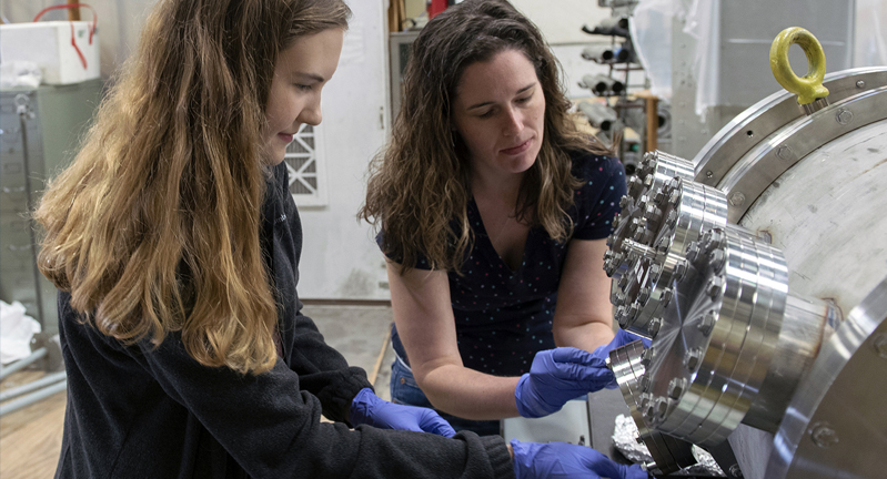 Two female researchers work to calibrate equipment settings within the Cyclotron Institute at Texas A&amp;M University.